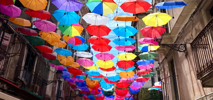 View of a part of the street with colorful umbrellas in Catania.